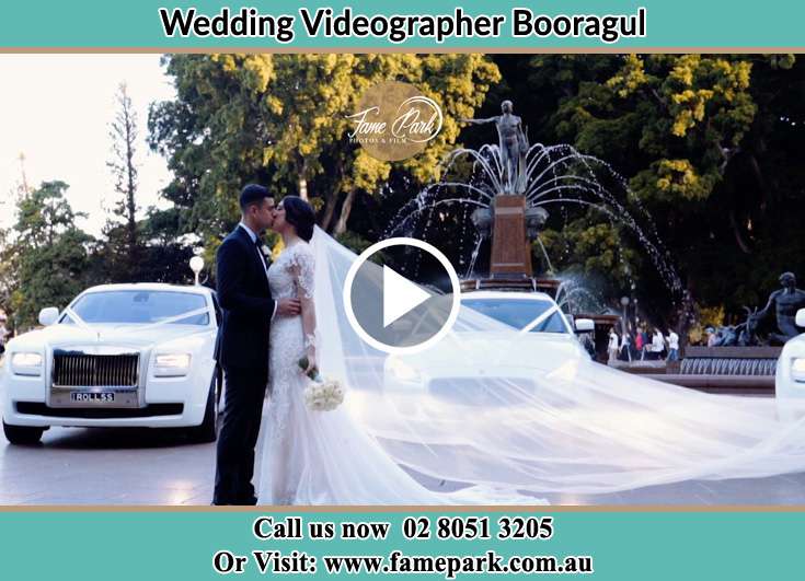 The Groom and the Bride kissing near the wedding car Booragul NSW 2284