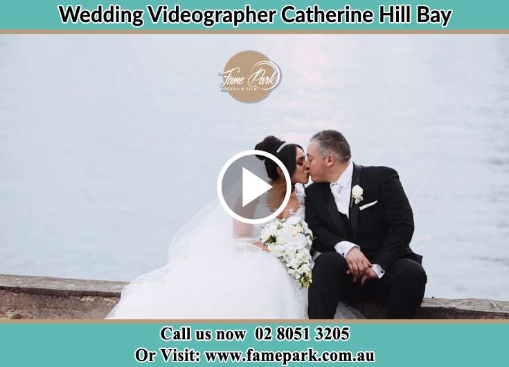 Bride and Groom kissing at the shore Catherine Hill Bay NSW 2281