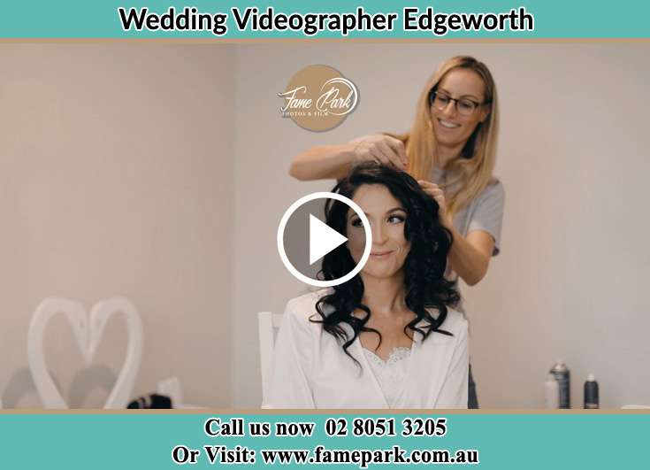 Bride getting ready through the help of her hair stylish Edgeworth NSW 2285