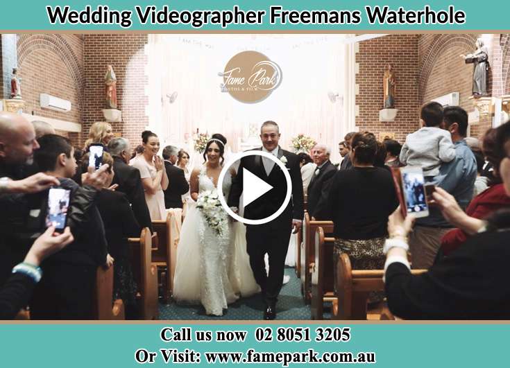 The newly weds walking through the well wishers Freemans Waterhole NSW 2323