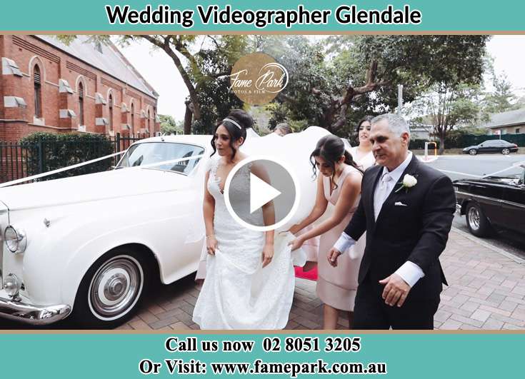 Bride her father and her secondary sponsors walk towards the church Glendale NSW 2285