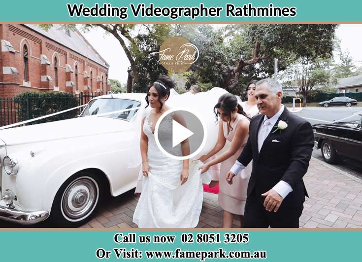 Bride her father and her secondary sponsors walk towards the church Rathmines NSW 2283